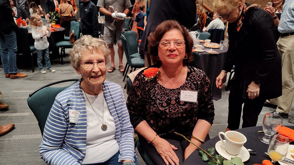 two women sitting together at at political event